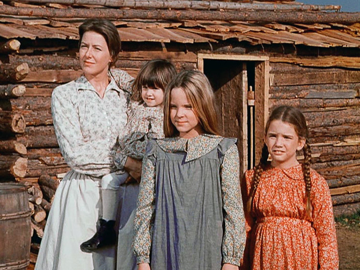 The family outside the cabin on the Kansas prairie