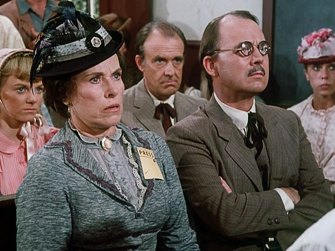Mrs. Oleson and her editor, Mr. Murdock (played by John Hillerman), are exposed in church