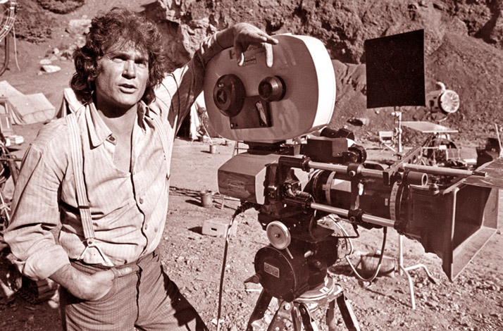 Michael Landon next to a film camera on location in Simi Valley